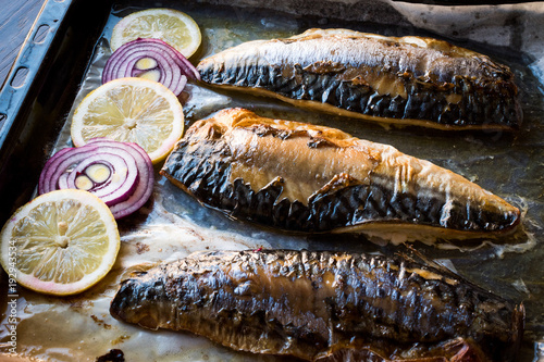 Mackerel Fish with Onions and Lemons in Baking Tray. photo