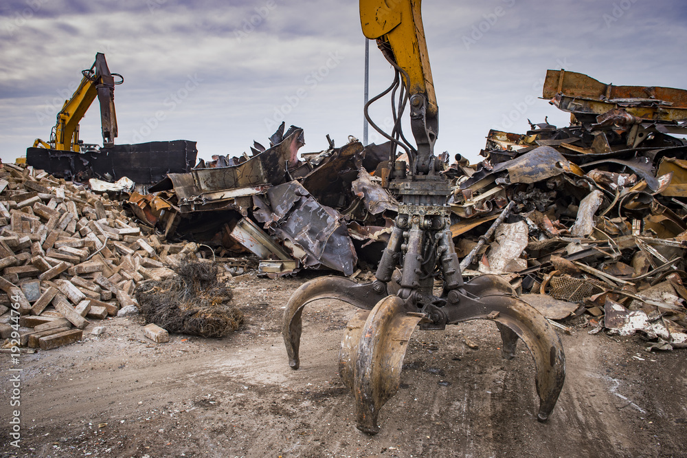 Fototapeta premium Scrap recycling plant, Crane grabber, pile metal to recycle