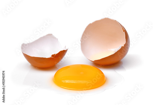 cracked egg with egg shell, egg yolk and egg white isolated on white background