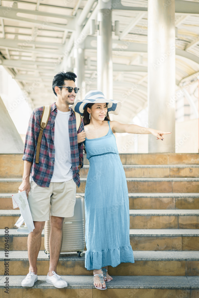 Young couple walking arm in arm and pointing fingers and looking something.. Couple, Love, Valentine, Travel and fashion in summer concepts.