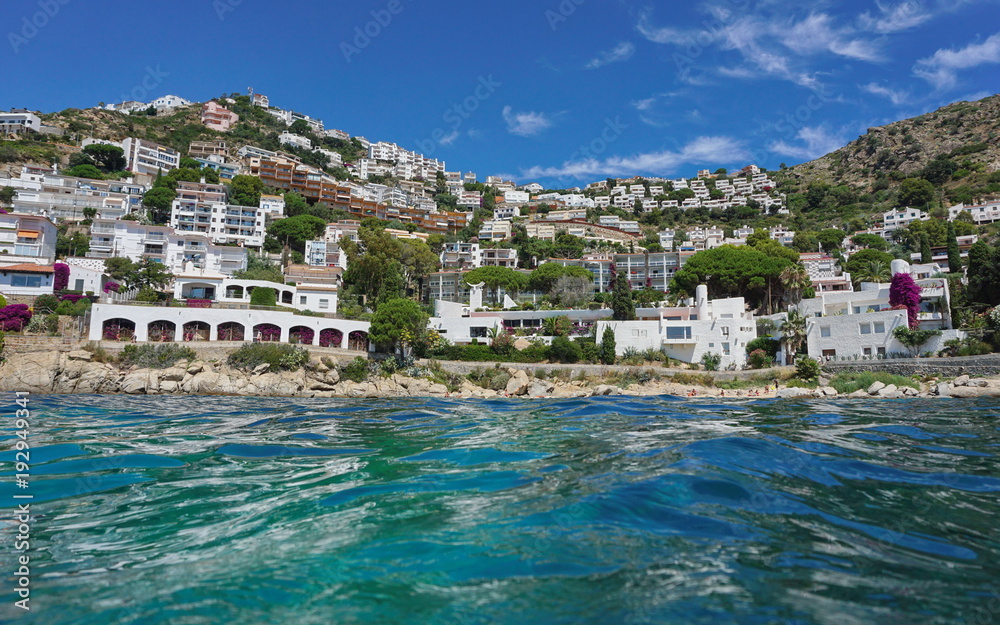 Spain Mediterranean coastline with buildings on the Costa Brava, seen from sea surface, Catalonia, Canyelles Petites, Roses, Girona