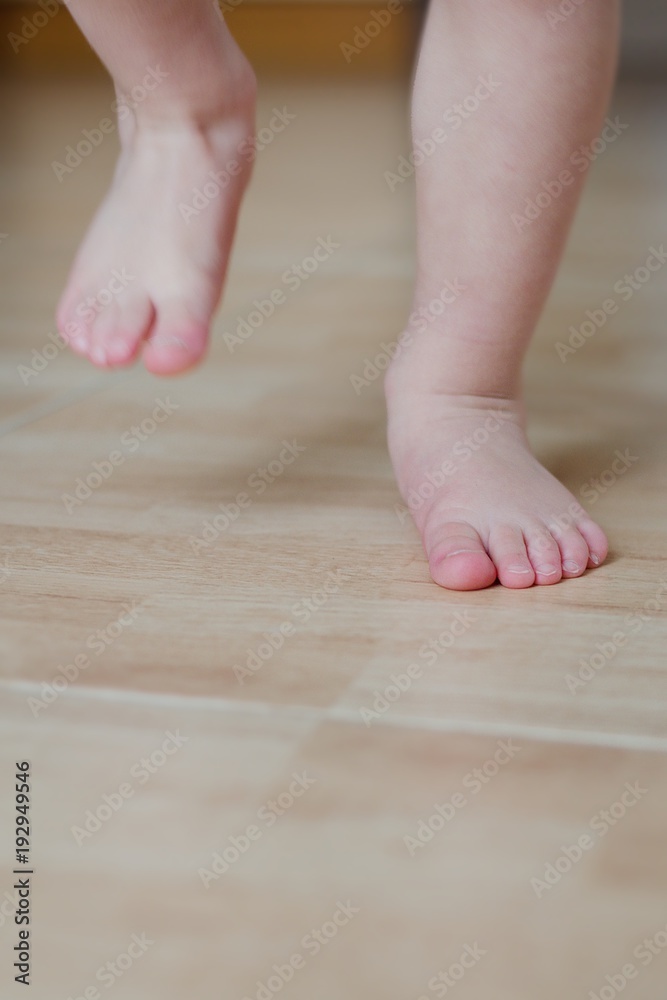 Baby foot running on a tiled floor Baby foot running on a tiled floor