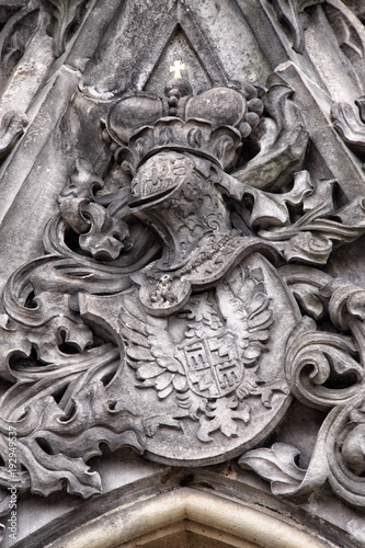 Plastic stony coat of arms above the window frame