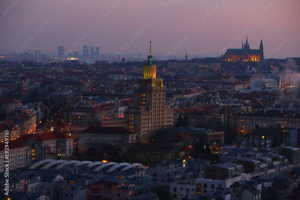 Evening cityscape if the Prague with lit houses and Castle