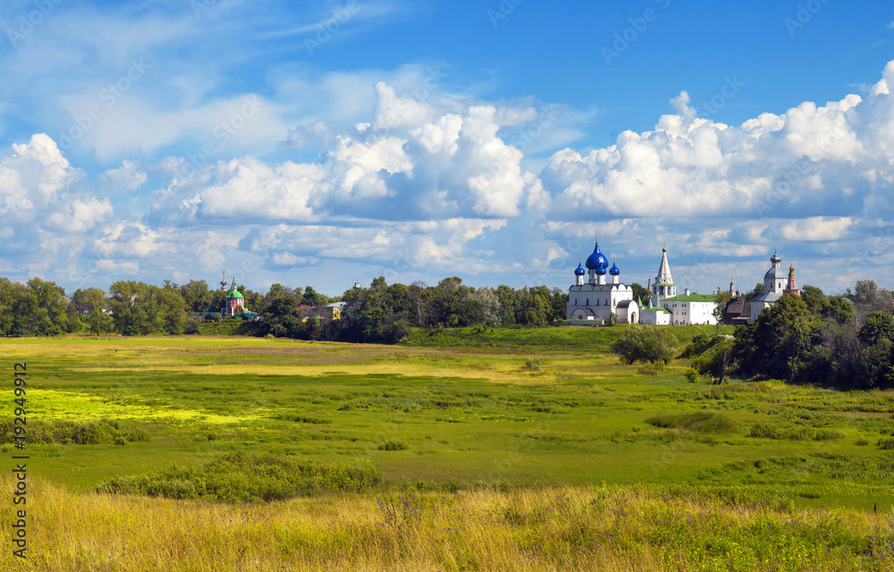 Suzdal, Russia. View of the field, sky and church Suzdal, Russia. View of the field, sky and church