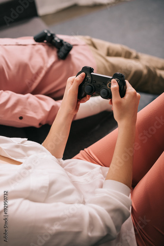 cropped shot of woman with manikin near by playing video game at home  loneliness concept
