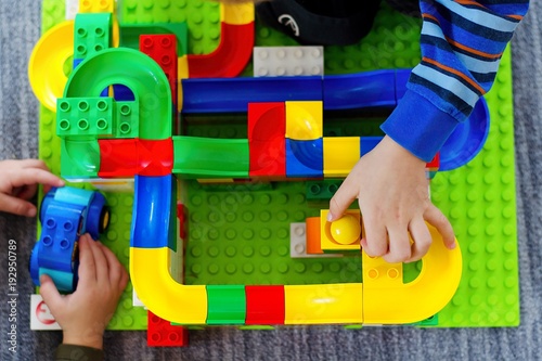 Child playing with marble race run track