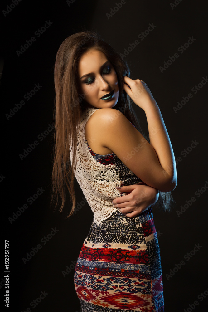 Adorable young woman with long hair and creative metallic makeup