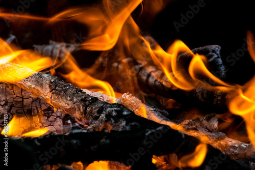 Photo of burning firewood and charcoal close-up