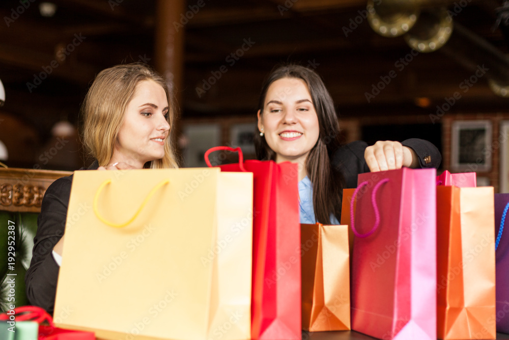 Adorable smiling girls having a sneak peek on gift bags Adorable smiling girls having a sneak peek on gift bags