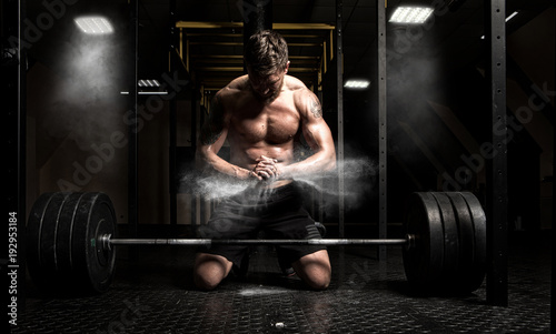 Muscular man clapping hands and preparing for workout