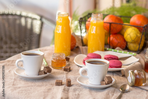 Breakfast with coffee cups  orange juice  makaron the outdoor terrace