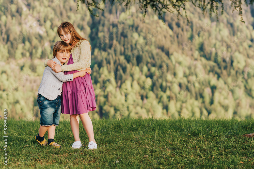 Two kids little boy and girl resting in mountains