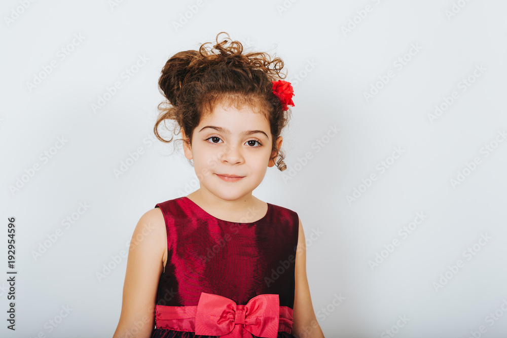 Studio shot of 5 year old kid girl with curly hair wearing party dress  Stock Photo | Adobe Stock