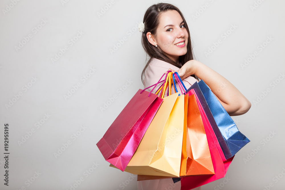 Beautiful smiling model girl holding shopping bags