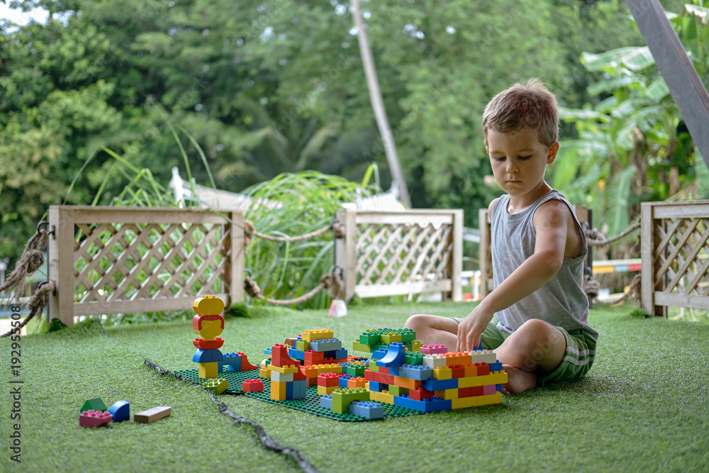 custom made wallpaper toronto digitalBoy playing with plastic construction toys. Amusement playground. Thailand