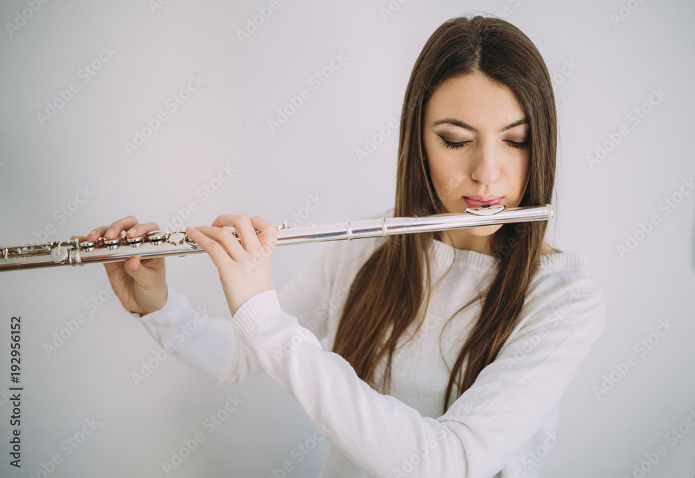 Female musician playing the flute. Female musician playing the flute.