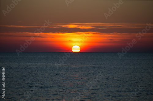 A beautiful sun setting on the horizon on the sea