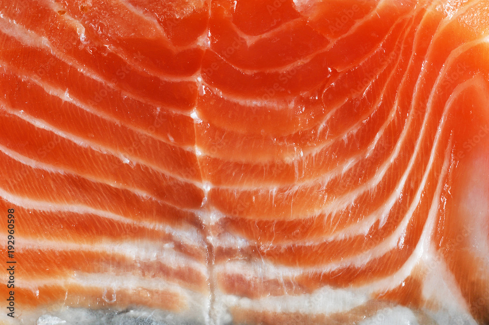 Slice of salmon fillet of weak salt. A slice of salmon takes up the entire frame space. View from above. Close-up. Macro photography.