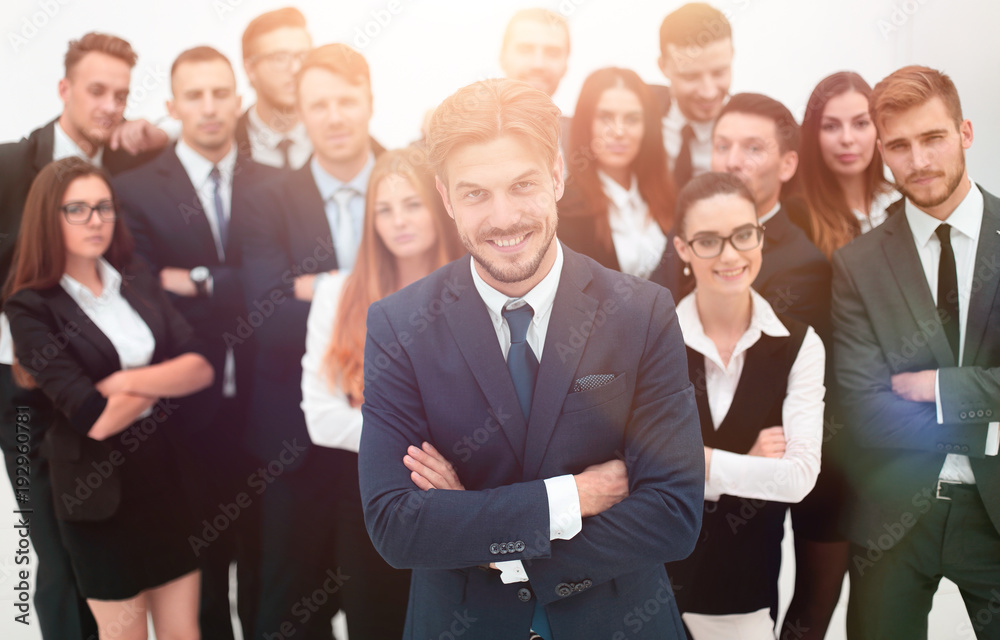 smiling businessman standing on background of her business team. smiling businessman standing on background of her business team.