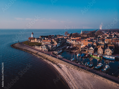 Lighthouse of urk on the rocky beach at the lake Ijsselmeer by the former island Urk Flevoland Netherlands, Bird eye view drone view of the old dutch village Urk photo