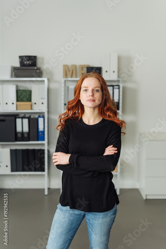 Serious confident young woman in an office