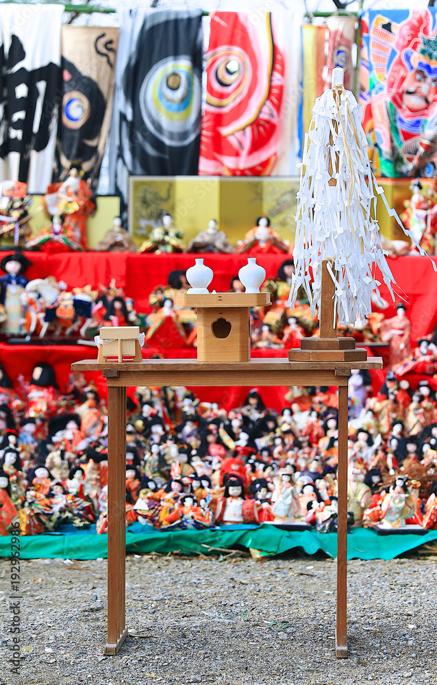 Fototapeta premium Japanese dolls & ritual articles set displaying on tiered stand during the Grand Bonfire Ceremony of farewell memorial service of old, used dolls at the Japan Shinto shrine Close up, Magnified image 2