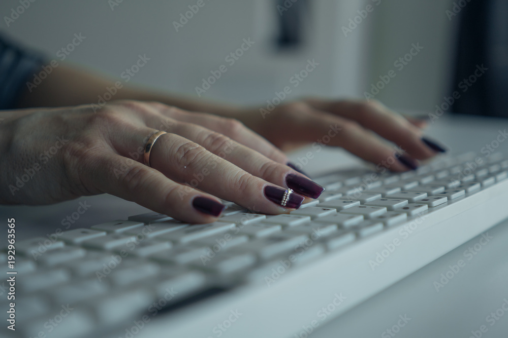 Female hands on the keyboard close-up. Keyboard in focus Female hands on the keyboard close-up. Keyboard in focus