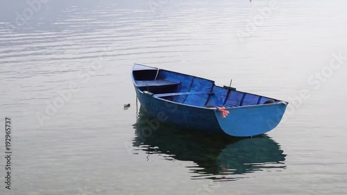 Blue boat floating in Ohrid Lake, Macedonia photo