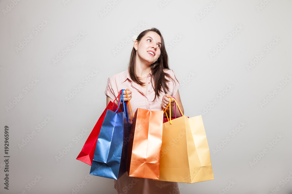 Young mother smiles carrying products to family Young mother smiles carrying products to family