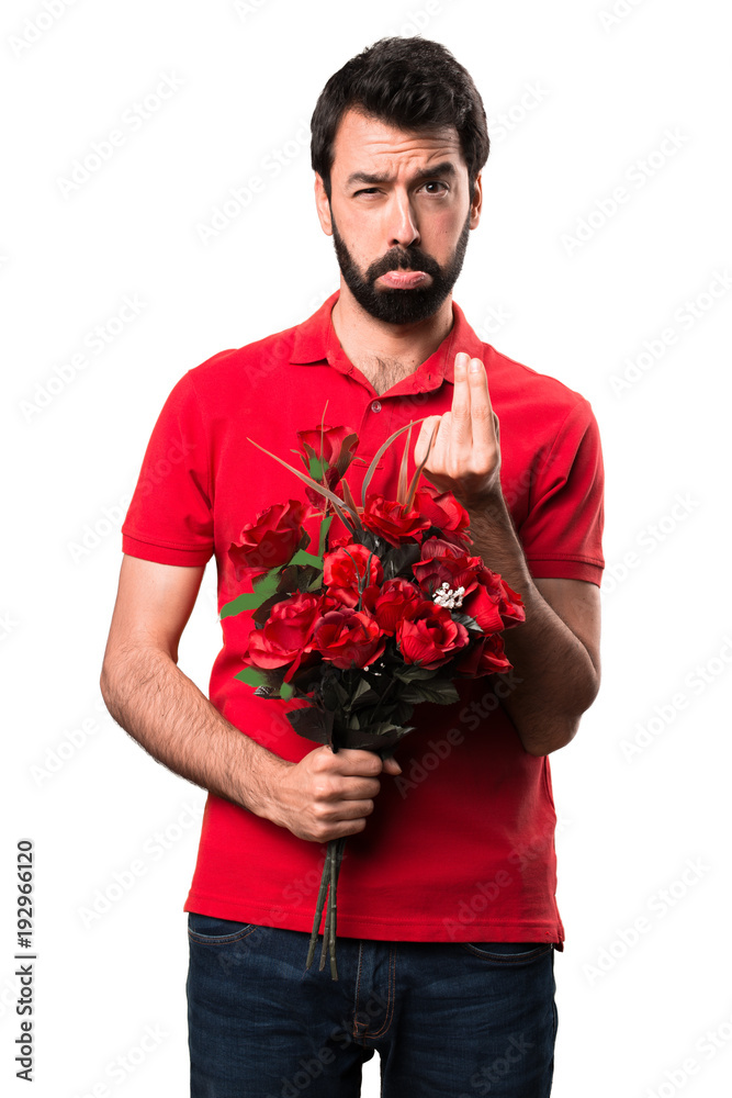 Ruined handsome man holding flowers over white background Ruined handsome man holding flowers over white background