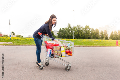 Young woman made all neccesary purchases for home