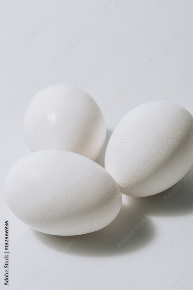 white eggs laying on white background