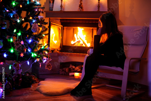 Woman relaxing by the fire place, winter weekends, cozy scene