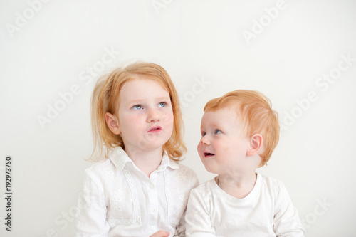 Sister and brother communicate on the white background
