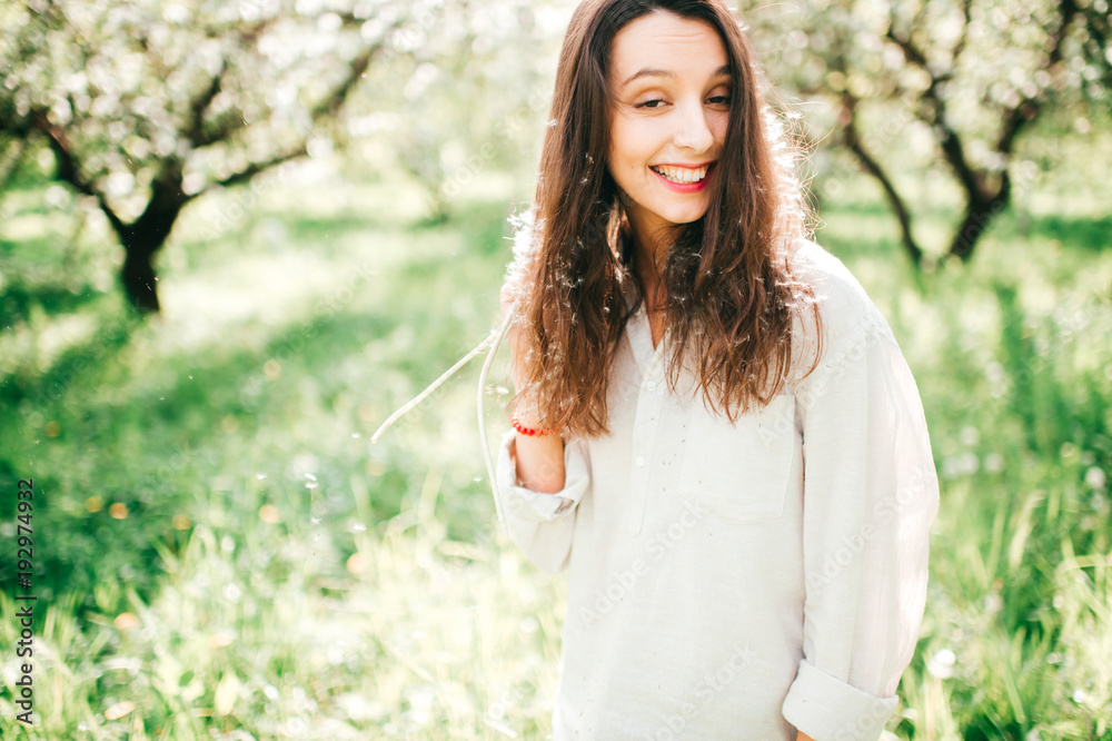 Spring is in the air. Nature ressurection after long sleep. Tender woman portrait in Japanese blooming emerald garden. Femininity of smiling happy cute girl with unusual lifestyle activity outdoor. Spring is in the air. Nature ressurection after long sleep. Tender woman portrait in Japanese blooming emerald garden. Femininity of smiling happy cute girl with unusual lifestyle activity outdoor.