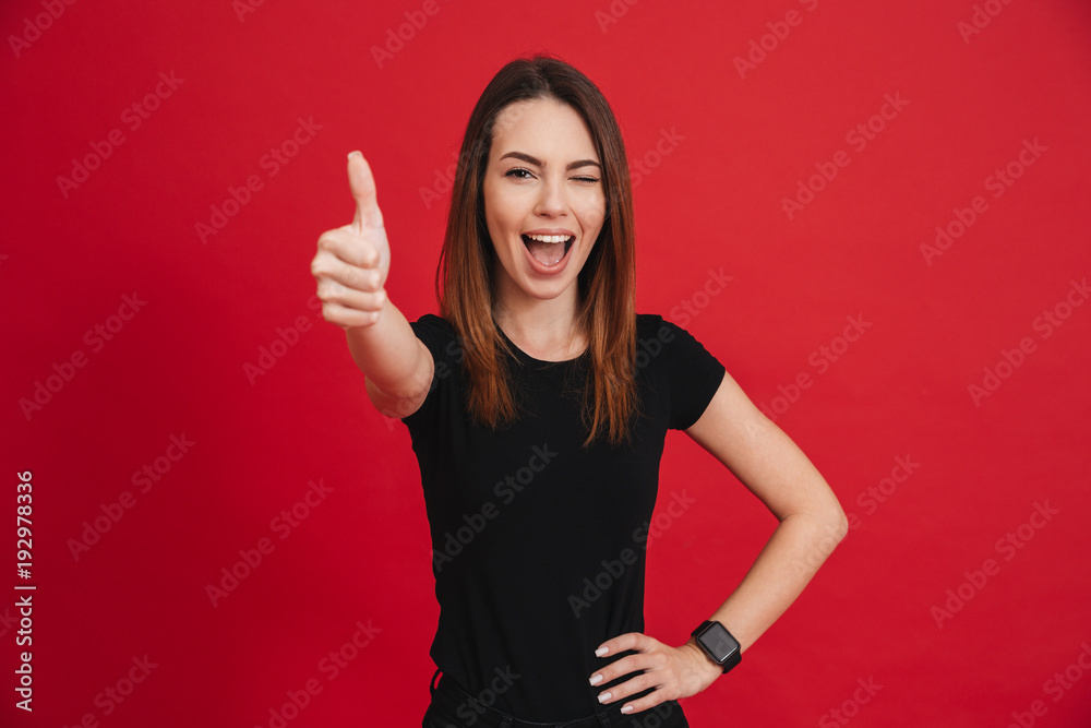 Portrait of a joyful casual girl showing thumbs up Portrait of a joyful casual girl showing thumbs up