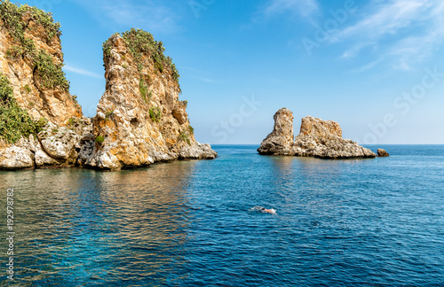 Landscape of Mediterranean sea with Faraglioni of Scopello at Zingaro Nature Reserve, Sicily, Italy