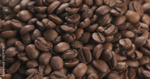 closeup coffee beans falling into bowl