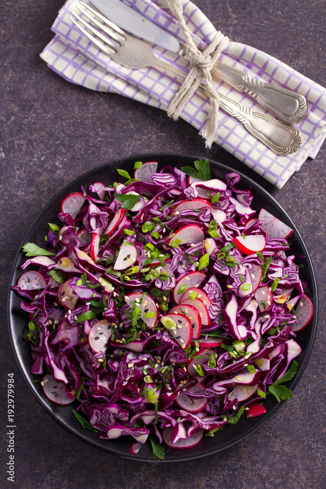 Red cabbage, radish, spring onion, parsley and sesame seeds salad. Vegetarian salad, healthy food concept. View from above, top, vertical