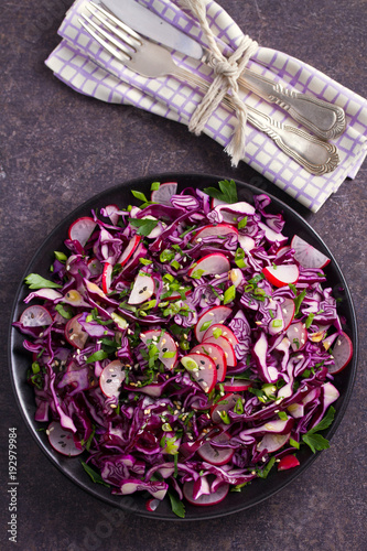 Red cabbage, radish, spring onion, parsley and sesame seeds salad. Vegetarian salad, healthy food concept. View from above, top, vertical