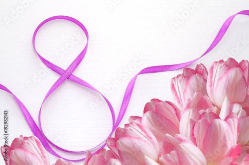 8 March International Women’s Day. Purple Ribbon and Tulips on a white background. Gift. Greeting Card. Invitation.