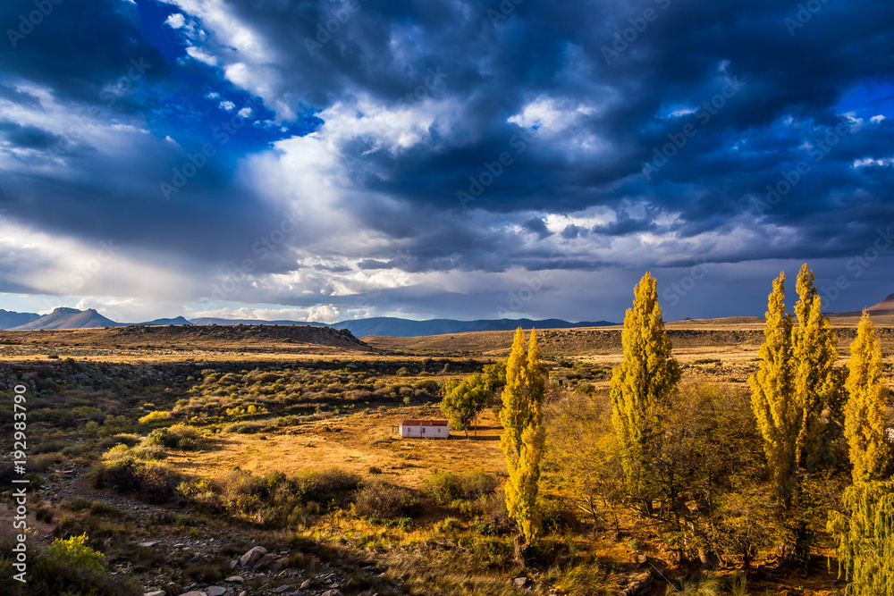 Dark storm clouds rolling in across the hills towards the town of Nieu Bethesda, Eastern Cape, South Africa.