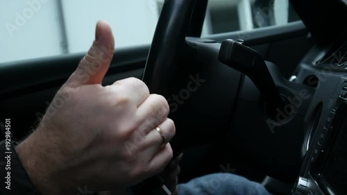 The driver turns off the engine and shows the OK, close-up