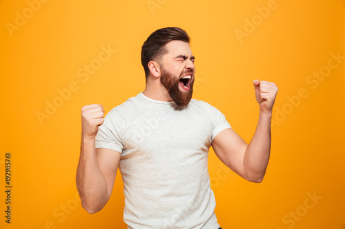 Portrait of a joyful bearded man celebrating success
