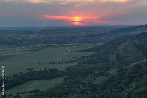 Beautiful landscape with a sunset sky and a green forest, aerial view, Dobrogea Romania
