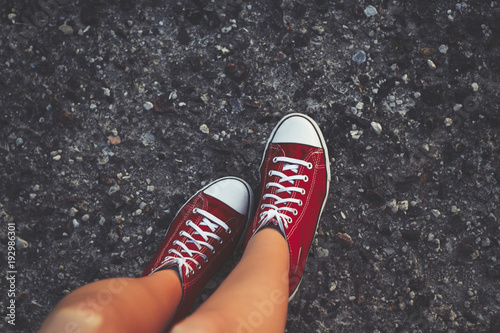 Cheerful young woman sexy legs and red shoes