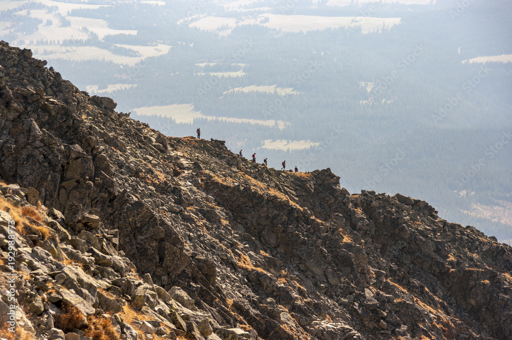 Naklejka premium Silhouettes of tourists on the Krywan ridge. High Tatra Mountains. Slovakia.
