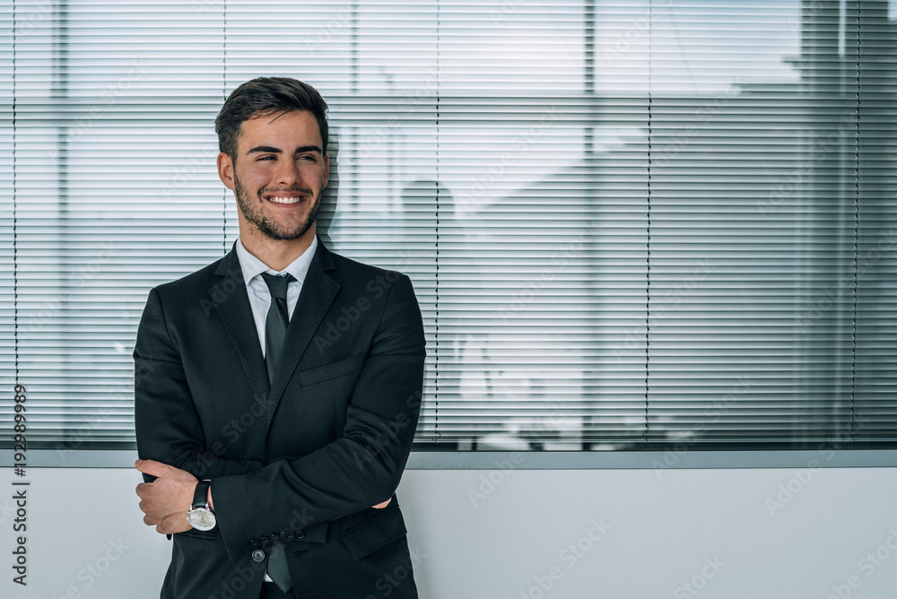 portrait of young businessman smiling at the airport with suit portrait of young businessman smiling at the airport with suit