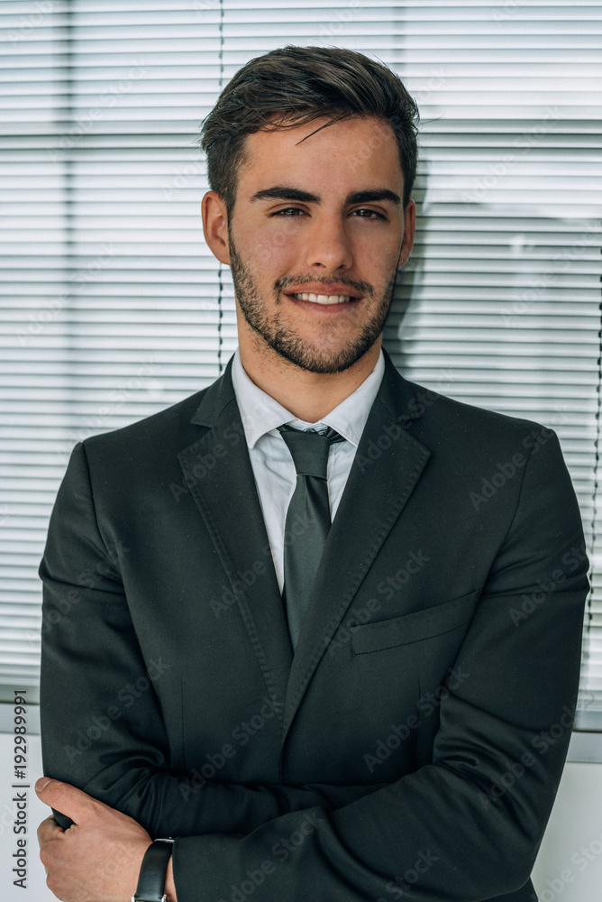 portrait of young businessman smiling at the airport with suit portrait of young businessman smiling at the airport with suit